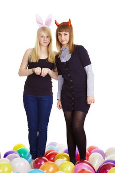 two attractive girls in the costumes of the hare and the devil. White background
