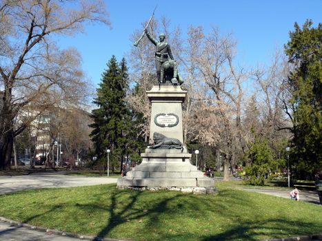 Pleven, Bulgaria - March 03, 2010: Spring day. Peoples walks near Monument for Serbian-Bulgarian war in central park.  Pleven, Bulgaria