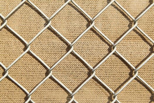 Metal fence with the light brown background