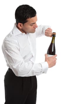 A man, bartender or waiter opens a bottle of champagne, sparkling wine.  He is untwisting the metal cage around the cork.  Sideview.   White background.
