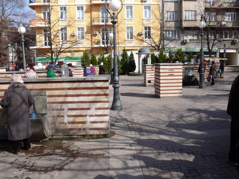 Sofia, Bulgaria - March 07, 2010: Peoples get the water in Public mineral springs. Sofia, Bulgaria