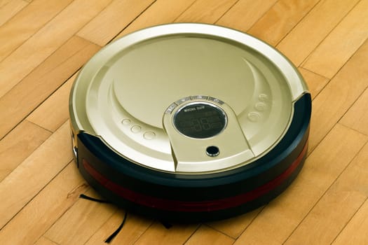 A robotic vacuum cleaner on parquet