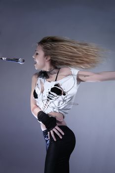 Portrait of female rock singer with microphone