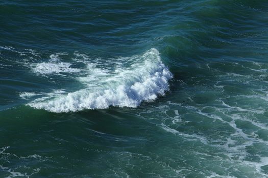 Aerial view of an incipient wave in an ocean.