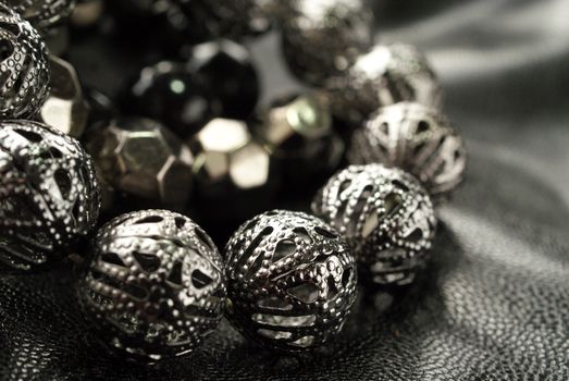 Dark Silver Bead Bracelets over black, shallow depth of field, suitable for backgrounds.