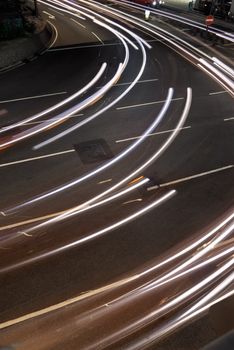 Urban night scene with cars motion blurred light in modern city.