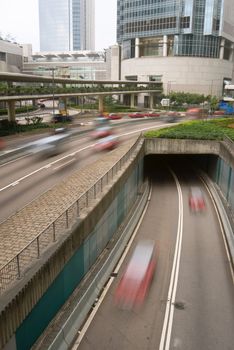 Business center scenery of cars on road with modern building in daytime in Hong Kong, Asia.