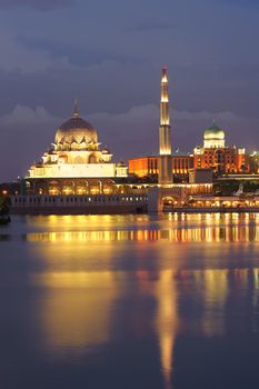 Night scene with colorful mosque and reflection on river in Putrajaya, Malaysia, Asia.