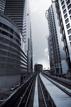 Cityscape of modern buildings and railway in city center.