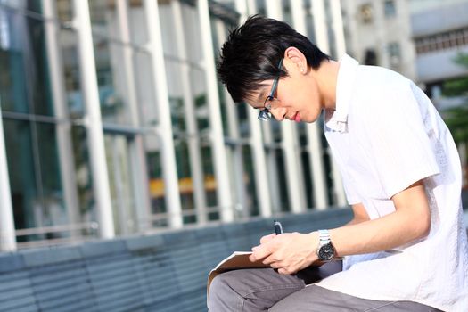 chinese man studing outdoor at day