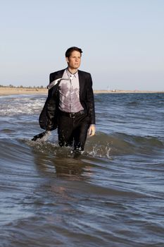 Fully dressed business man on the water .
