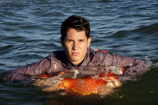 Business man holds a lifesaver buoy on the water.