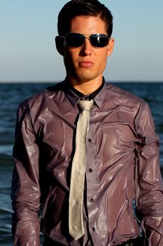 Fully dressed business man on the water .