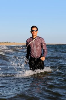 Fully dressed business man on the water .