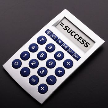 success concept with word on business calculator