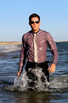 Fully dressed business man on the water .