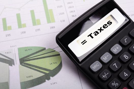 tax or taxes concept with business calculator and word