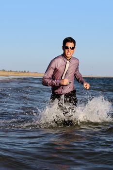 Fully dressed business man on the water .