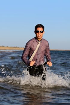 Fully dressed business man on the water .
