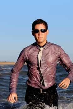 Fully dressed business man on the water .