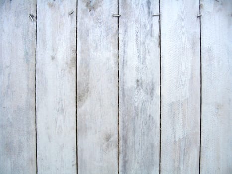 Old painted boards of the fence with nails 