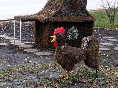 Decorative flowerbed with cock from plant