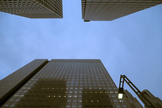 twilight sky of modern city among huge skyscrapers walls rising up, Shinjuku area, Tokyo, Japan