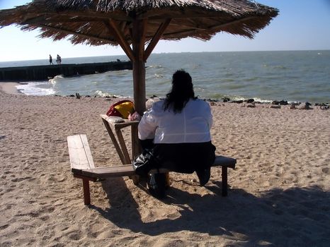 obese woman not to stir from a place beside seeshore