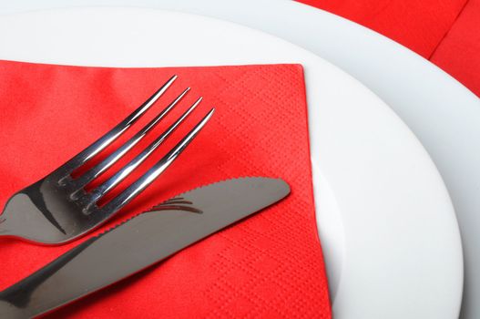 stainless fork knife and plate set on a table