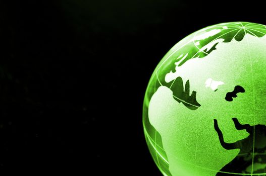 glass globe on black background showing business or environment concept with copyspace