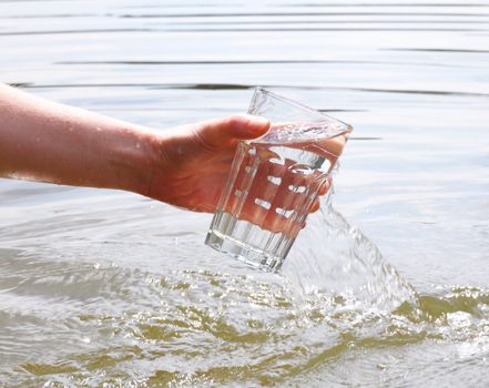 drink water concept with hand and glass in summer