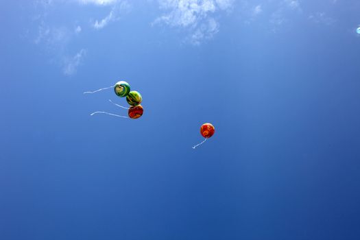 colorful balloons on blue sky 
