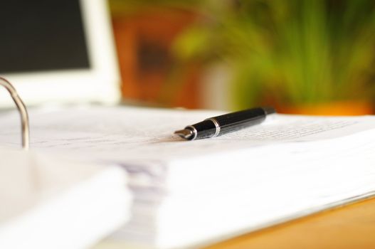 business desktop still life with folder pen copyspace and laptop in office