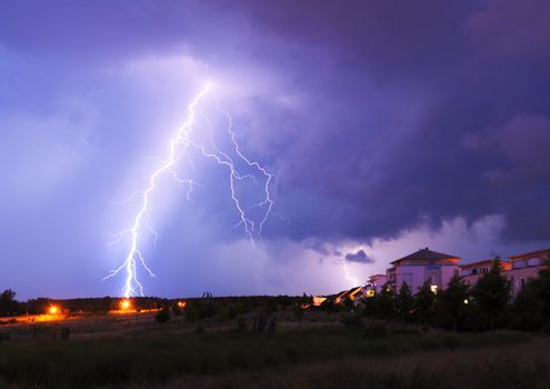 lightning on a thunderstorm in a park with cloudy sky