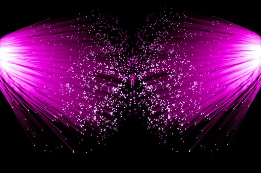 Two illuminated groups of bright pink fibre optic strands emanating from the left and right of the image. Black background.