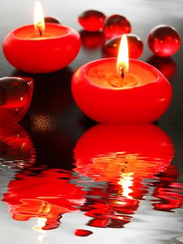 spa candle and water reflection showing zen concept