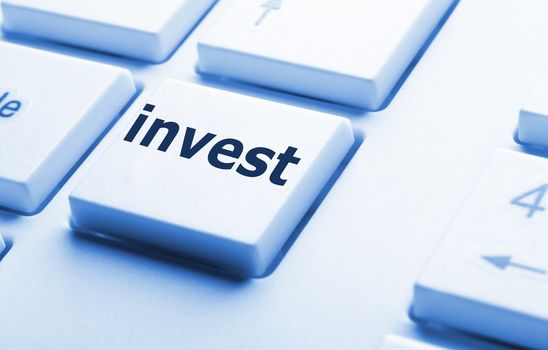 invest key on keyboard showing financial business investment concept