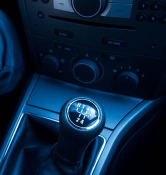 Gearstick of a car, blue toned background image