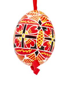 red hanging hand painted easter egg on white background