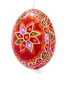 red hanging hand painted easter egg on white background