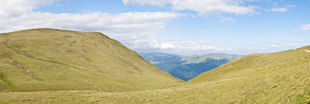 Panorama background in Carpathians. Beautiful mountains and landscape in Romania.