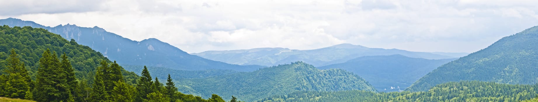 Panorama background in Carpathians. Beautiful mountains and landscape in Romania.