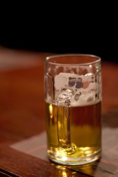 A half-drunk mug of beer in a bar