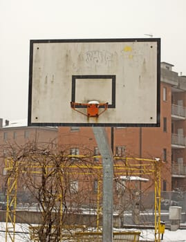 Basket for basketball in the snow of a park