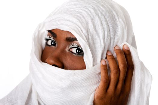 Beautiful female face in white scarf showing eyes with white lashes.