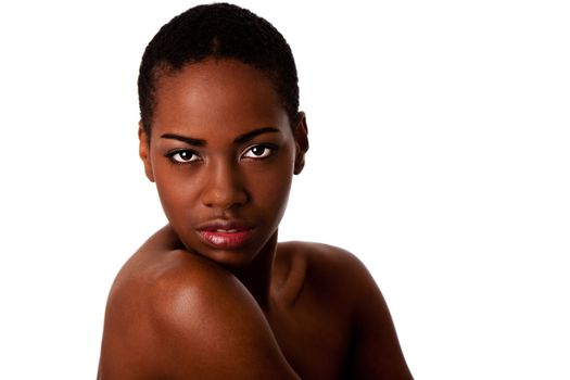 Beautiful African female face with short curly hair looking over shoulder, isolated.