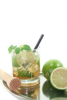 Mojito on a tray with fresh lime and lemon balm