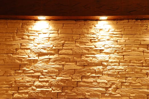 grey and unshaped stone wall with spot lights