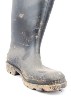 one muddy farmer boot isolated on a white background
