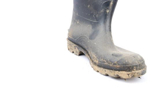 one muddy farmer boot isolated on a white background